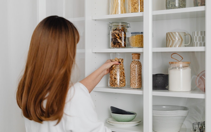 a woman looking in the pantry