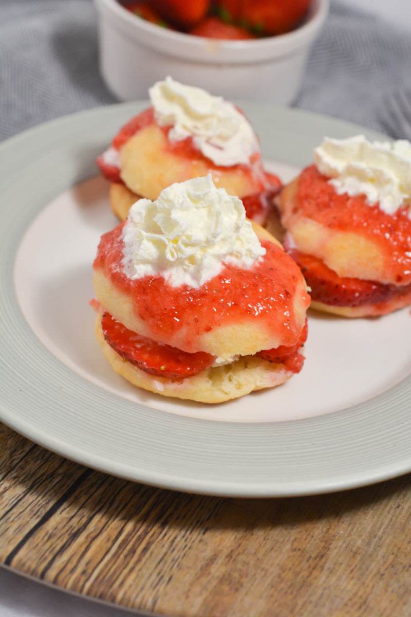 strawberry shortcakes with whipped cream on a white plate