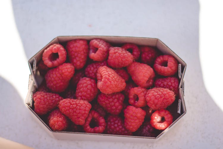 raspberries in a container