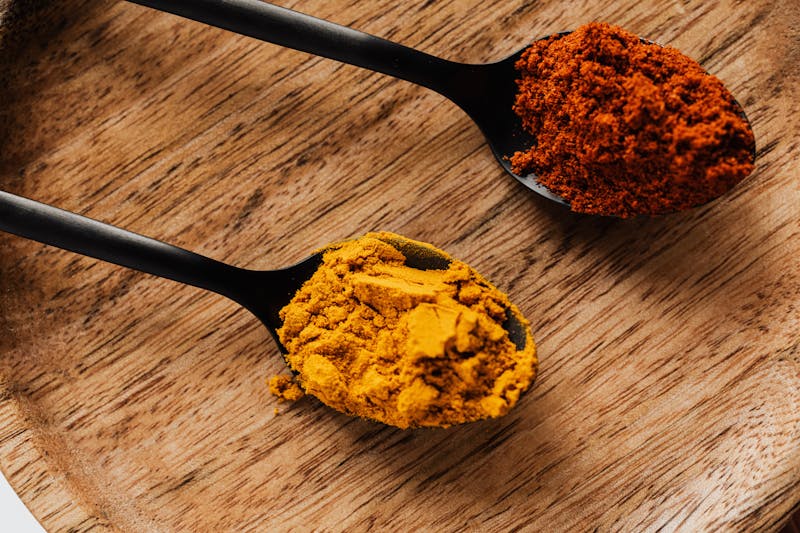 turmeric and paprika on spoons